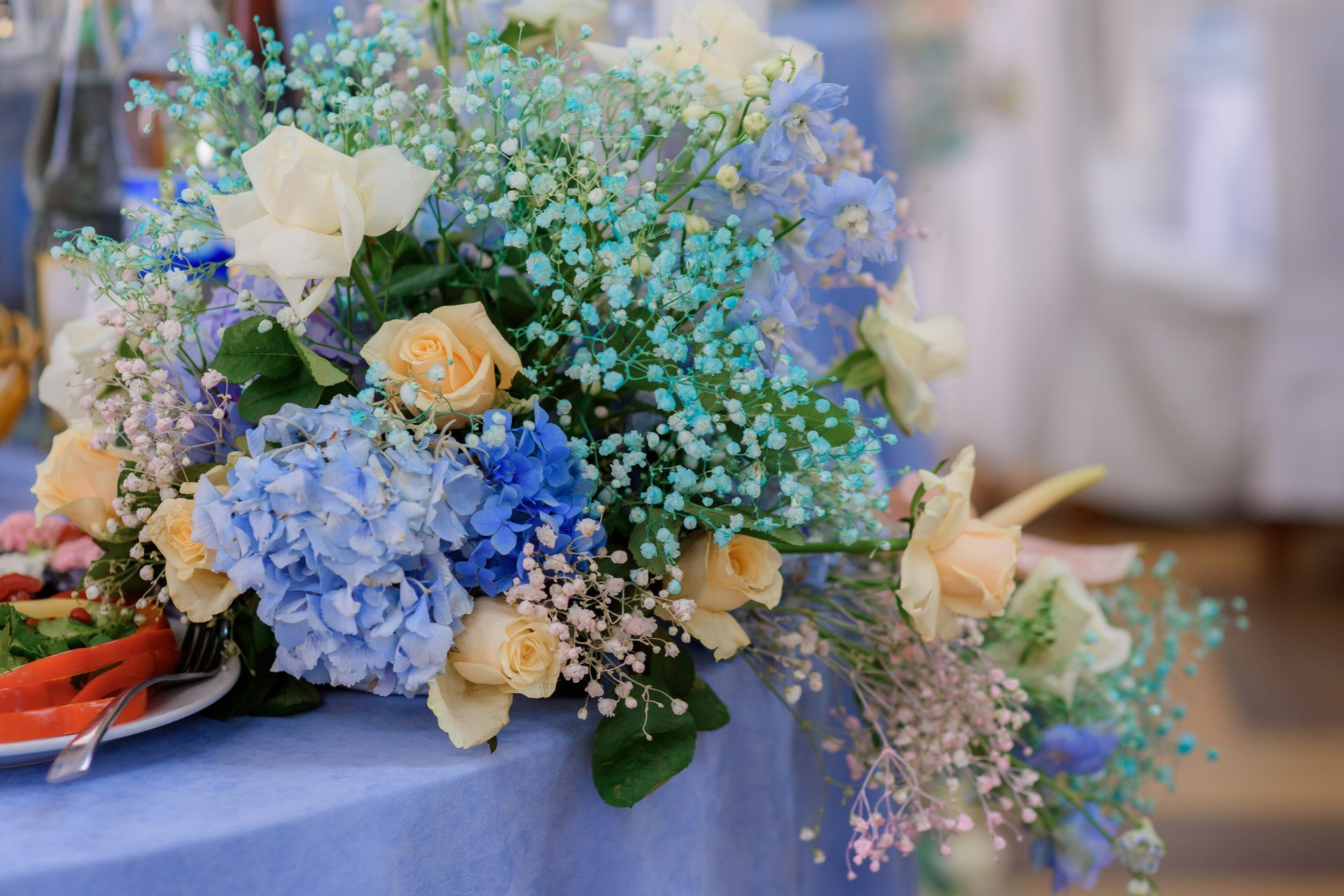 A bouquet of blue and white flowers is sitting on a table.