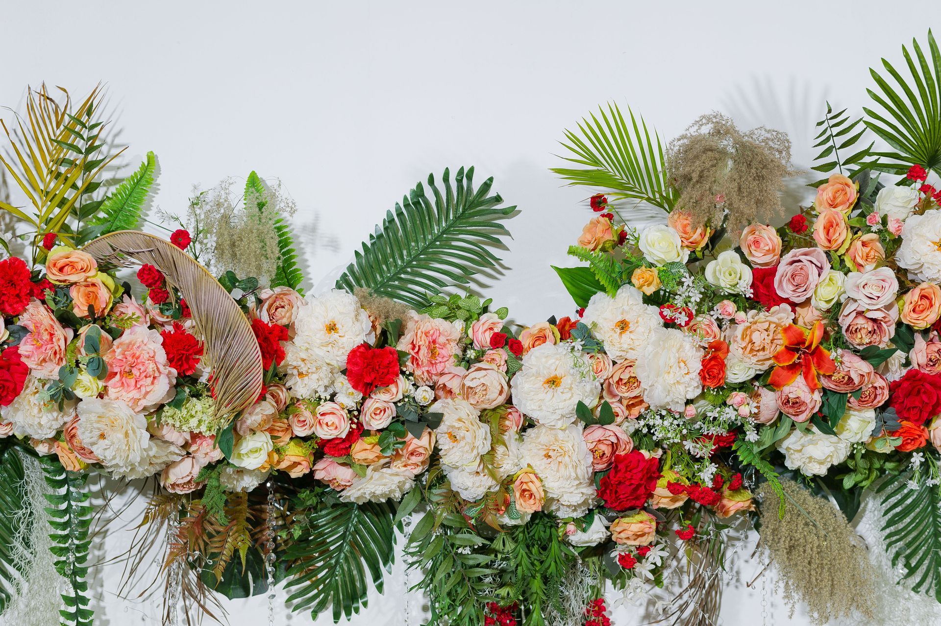 A long row of flowers and leaves on a white background.