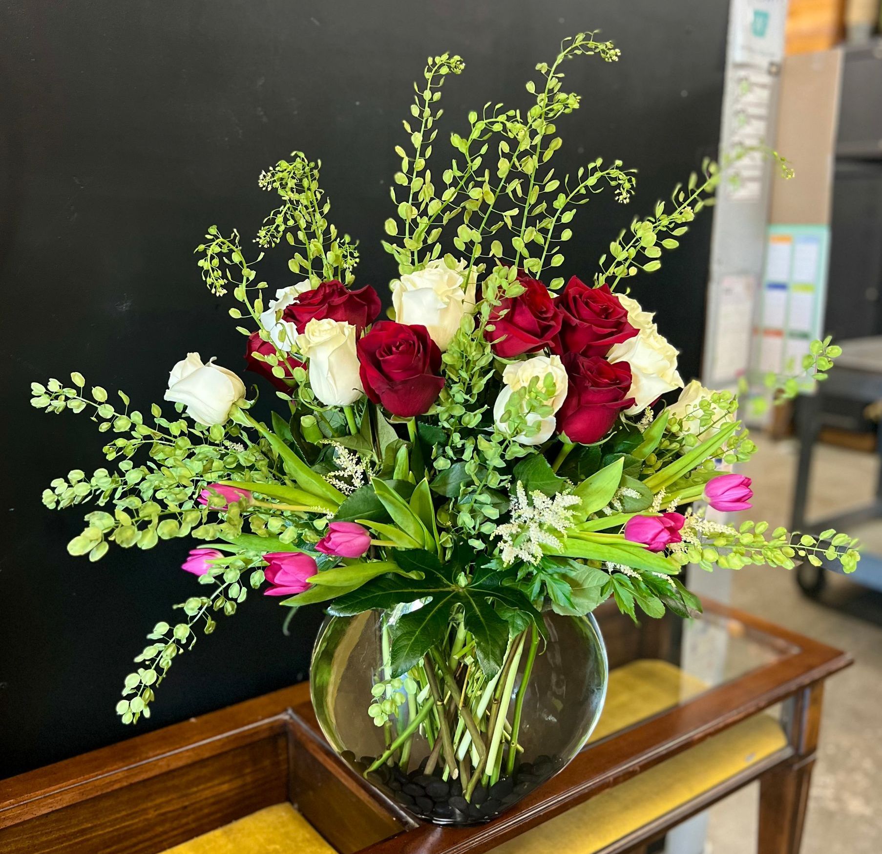 A vase filled with flowers is sitting on a table.