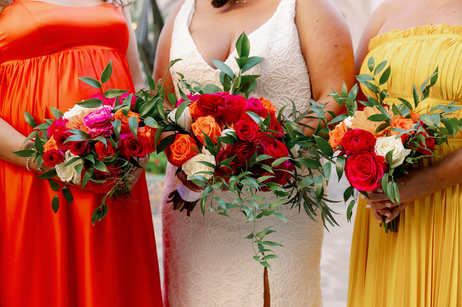 A bride and her bridesmaids are holding bouquets of flowers.