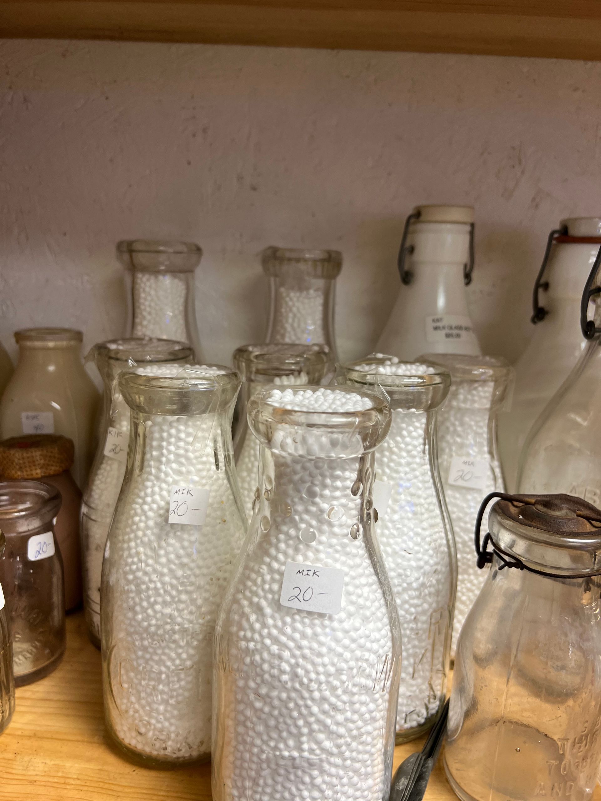 A bunch of glass bottles filled with white beads