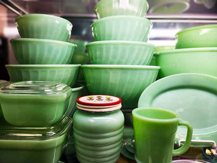 A stack of green bowls and plates on a table