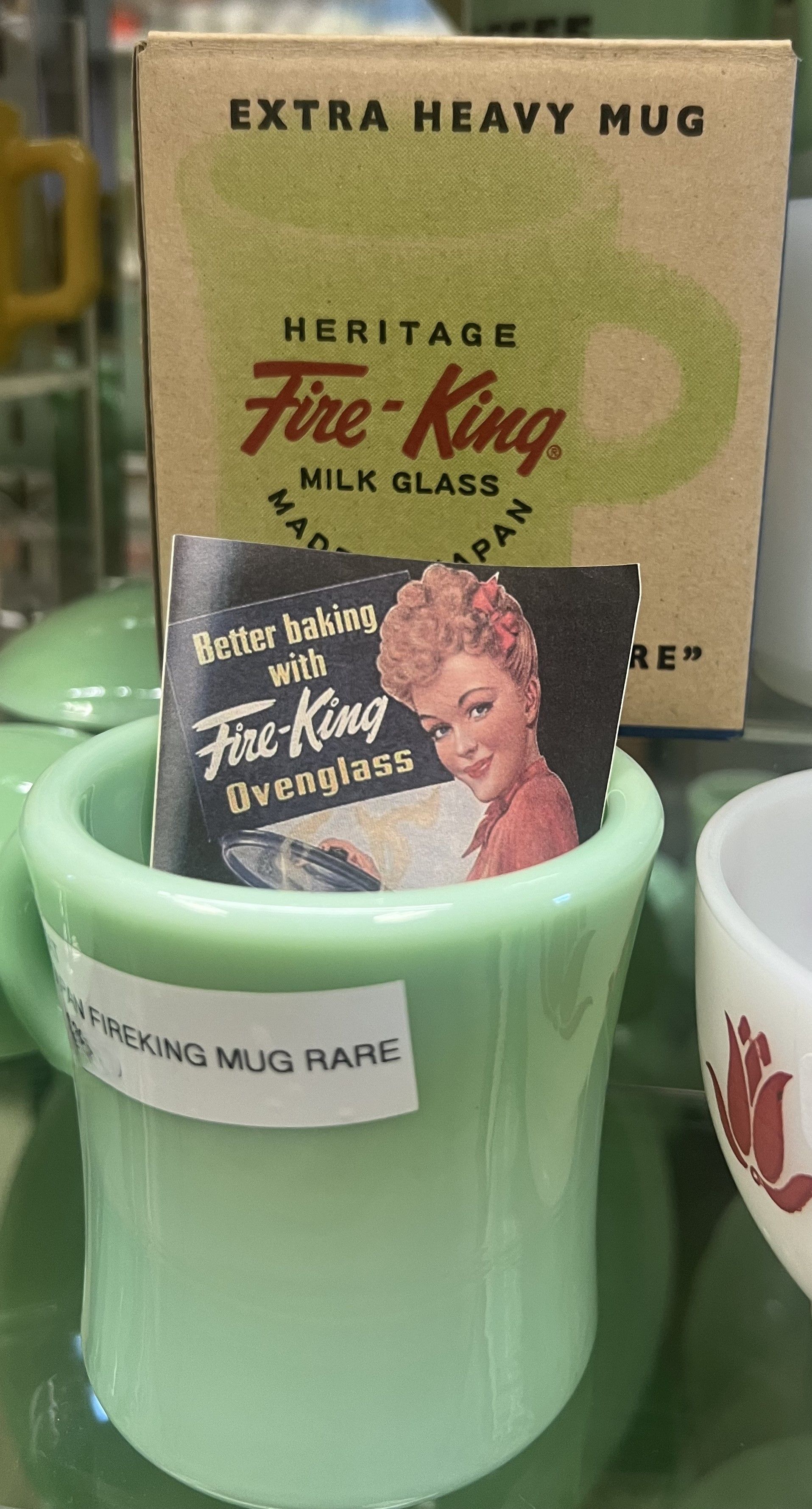 A green mug with a label that says extra heavy mug