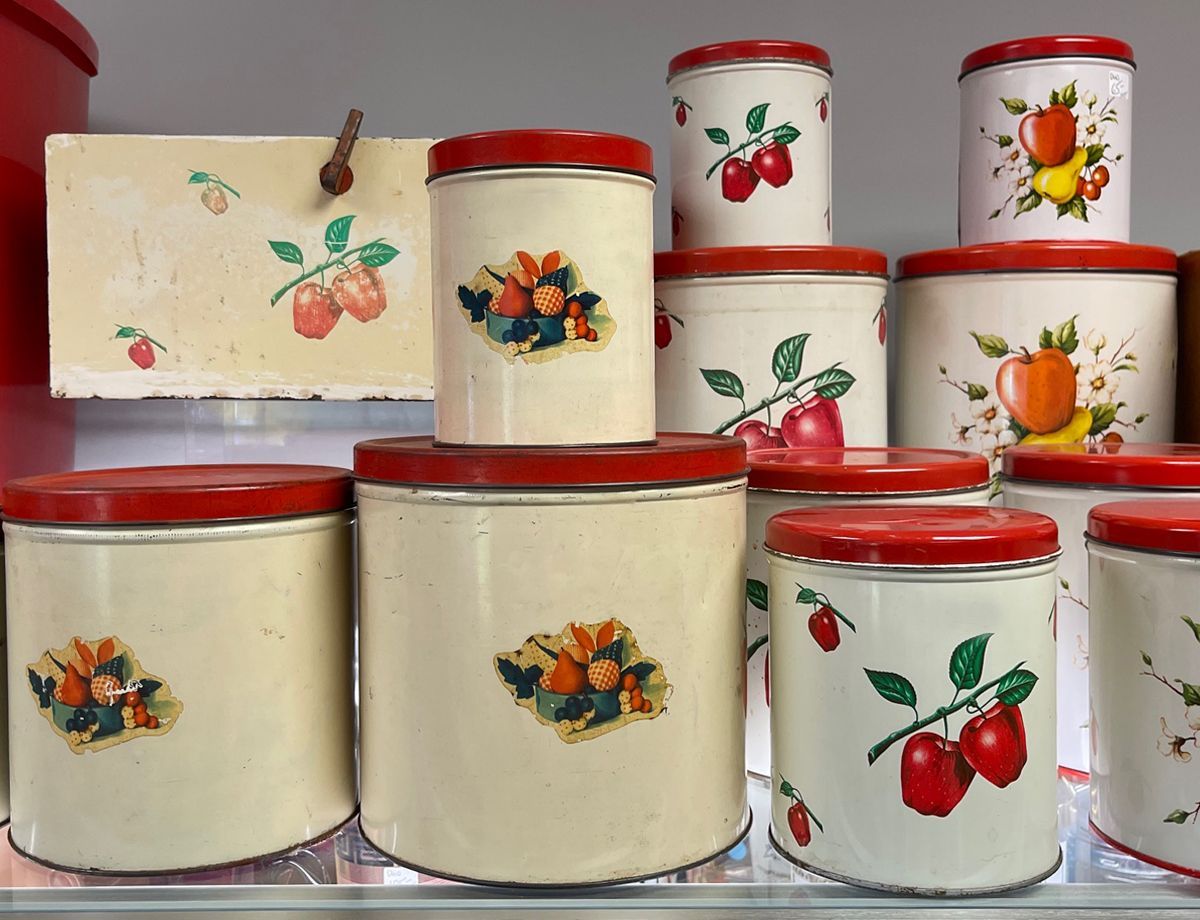 A bunch of cans with fruit designs on them