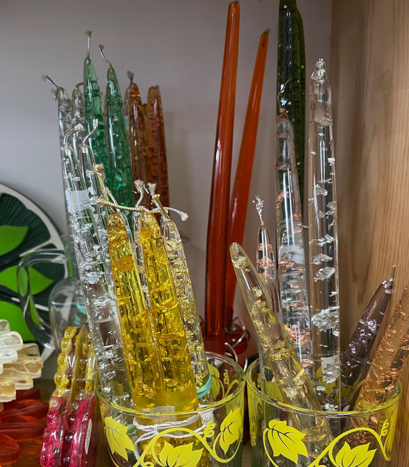 A glass with a heart on it is filled with candles