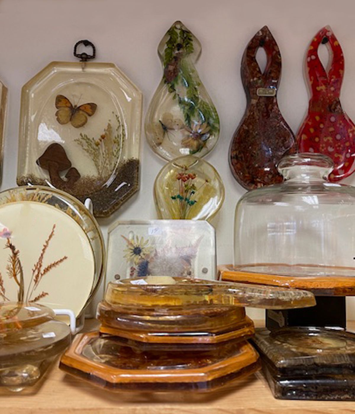 A display of plates and jars with a butterfly on one of them