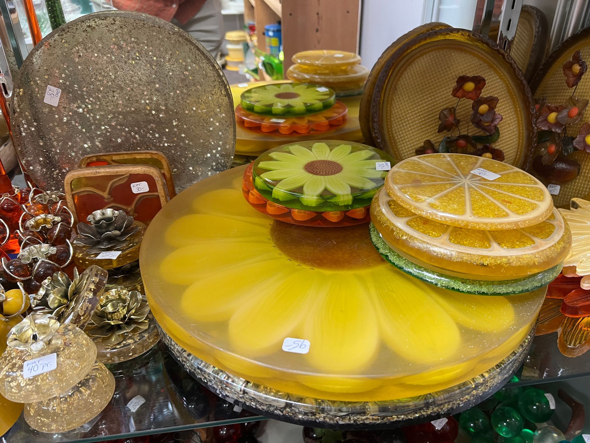 A display of plates and bowls with a yellow flower on top