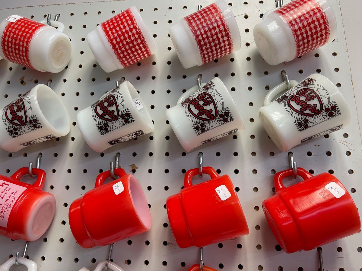 A row of red and white mugs 