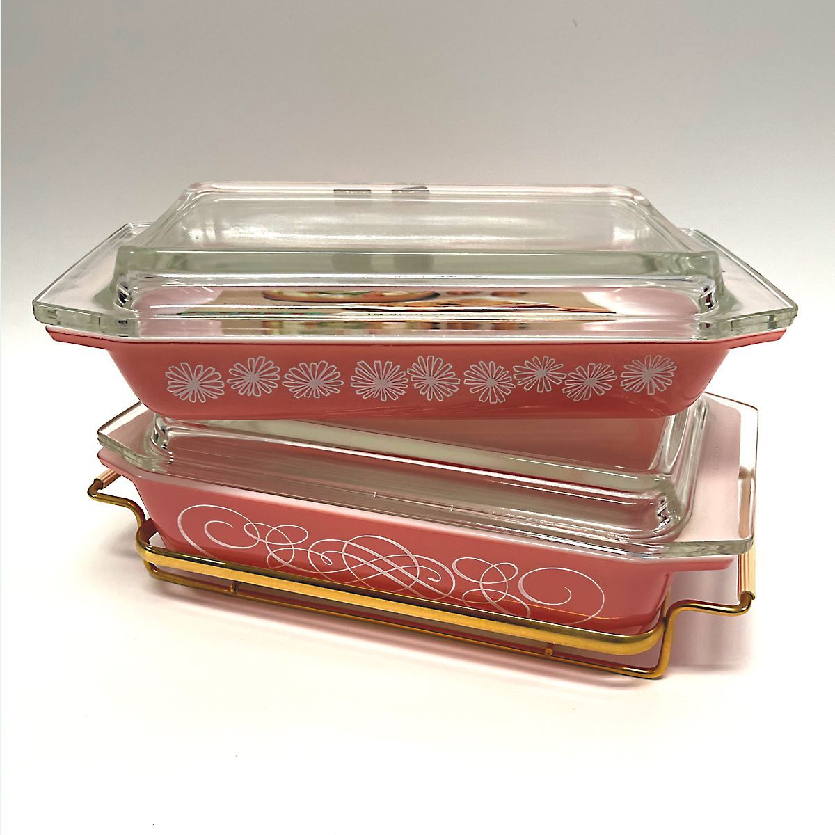 Pyrex pink daisy and scroll patterned casserole dishes