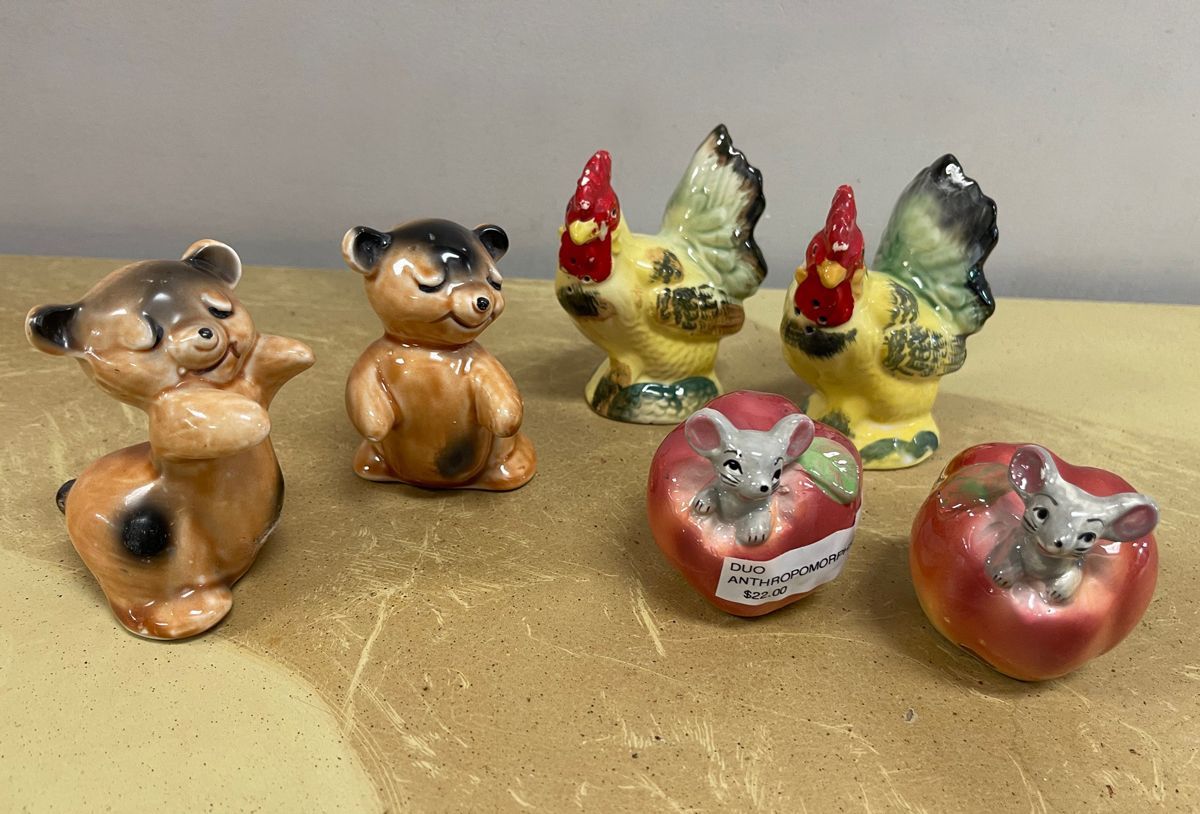 A group of salt and pepper shakers are sitting on a table