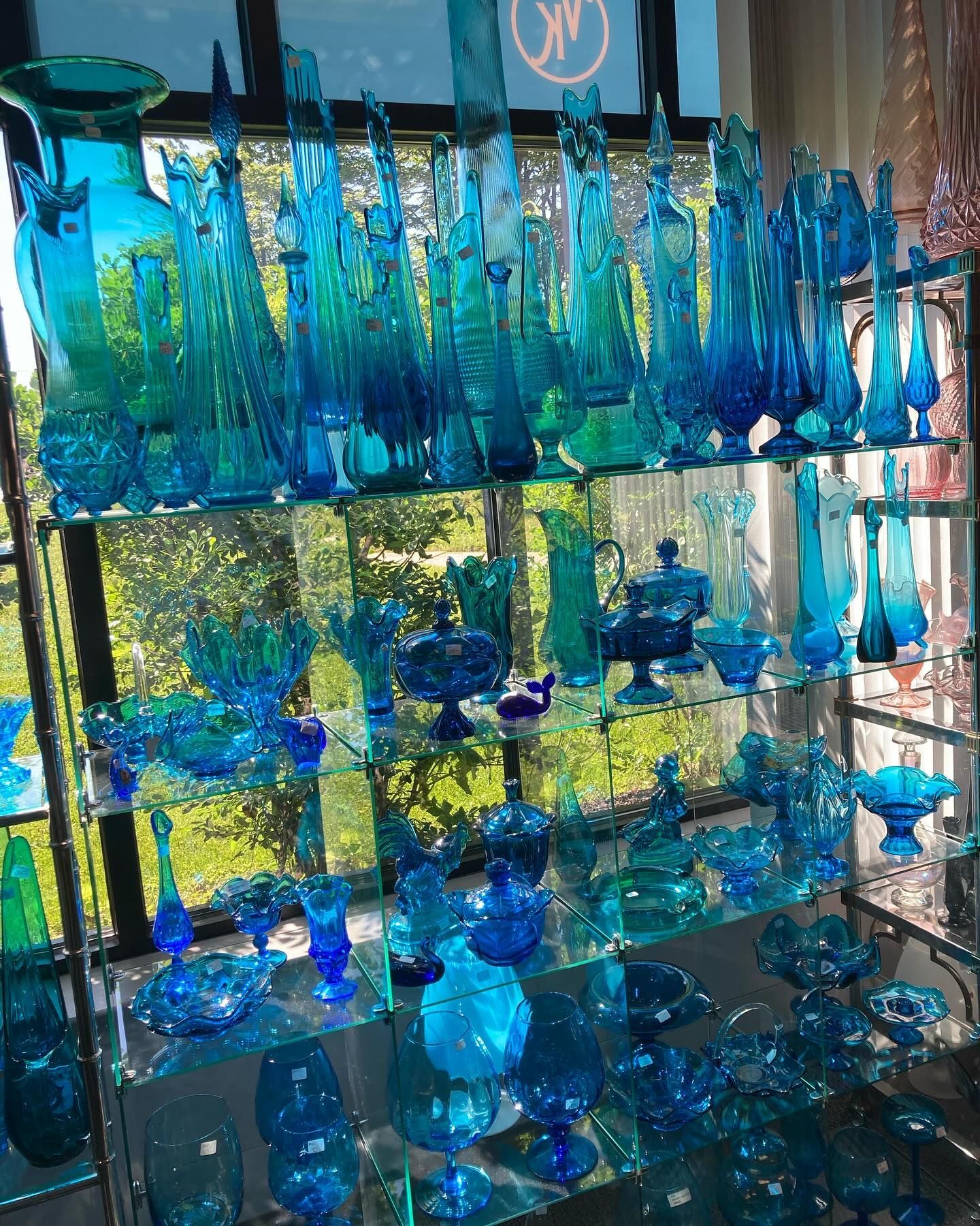 A display of blue glassware including vases and pitchers
