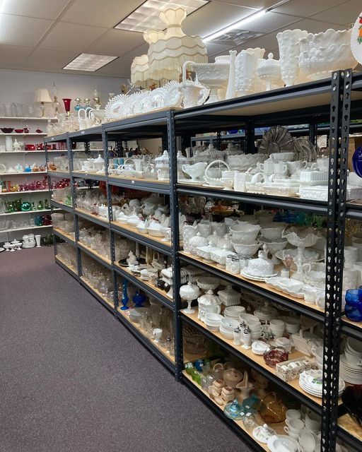 Shelves in a store filled with lots of white glassware