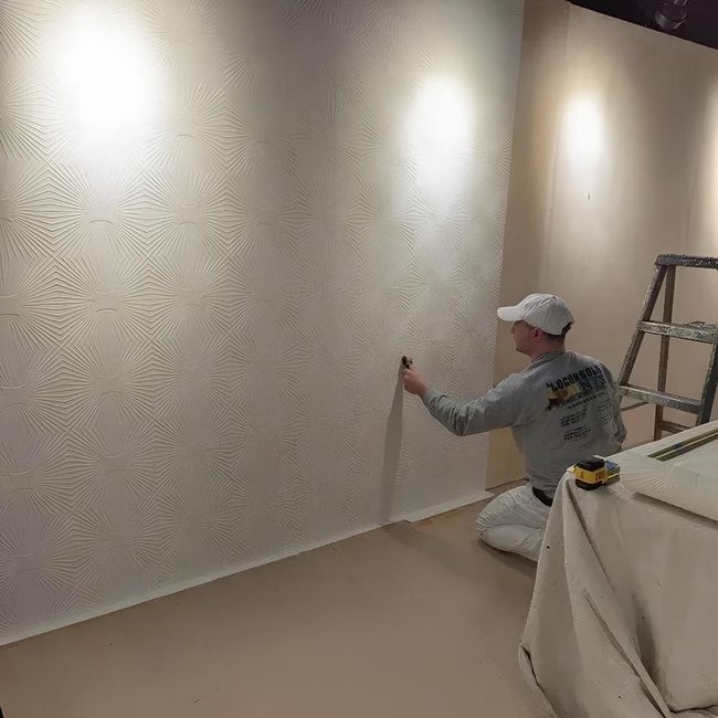 Painter mural with starburst wall texture and renovation tools.