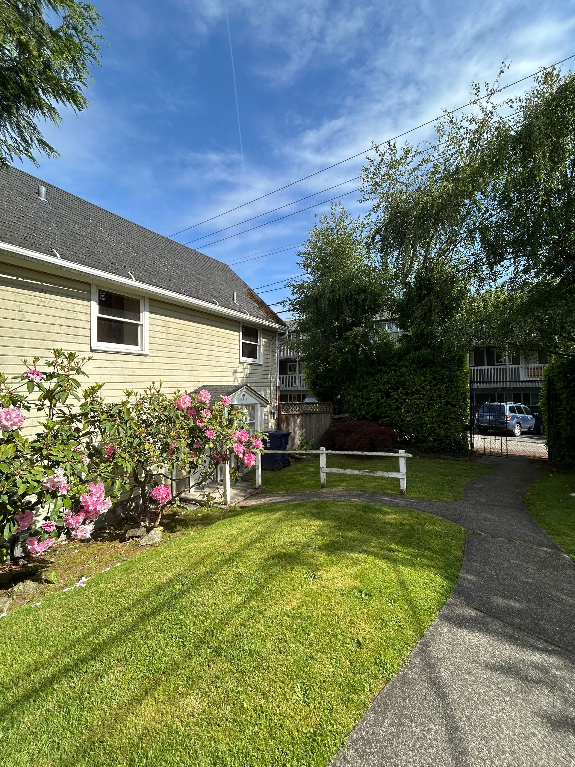 A house with a fence in front of it and a path leading to it.