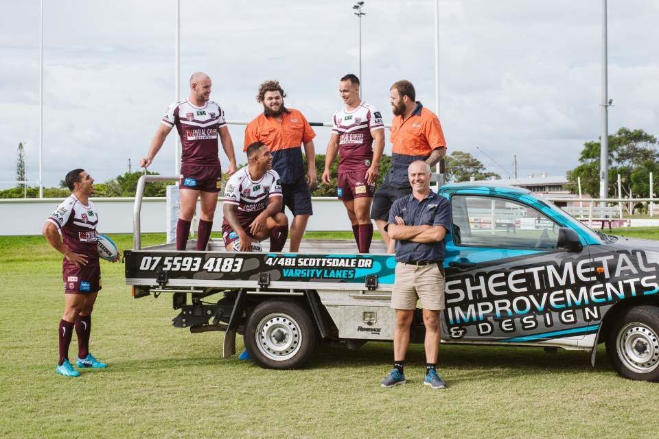 Rugby Team and Man Pose on a Truck With Sheet Metal Business — Sheetmetal Improvements & Design in Burleigh Heads, QLD