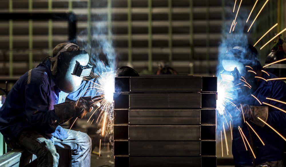 Workers Welding Metal in a Factory — Sheetmetal Improvements & Design in Burleigh Heads, QLD