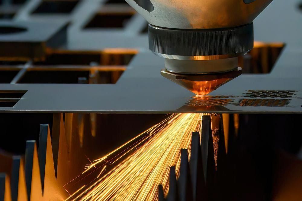 Laser Cutting Sheet Metal, Sparks Flying — Sheetmetal Improvements & Design in Yatala, QLD