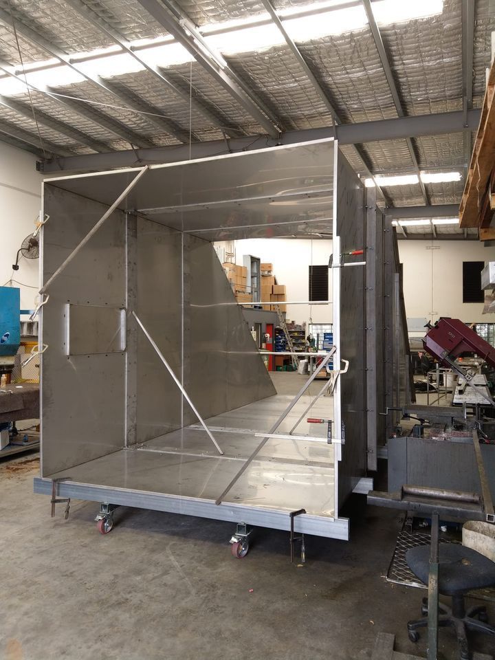 A Large, Unfinished Metal Box On Wheels Inside A Workshop — Sheetmetal Improvements & Design in Southport, QLD