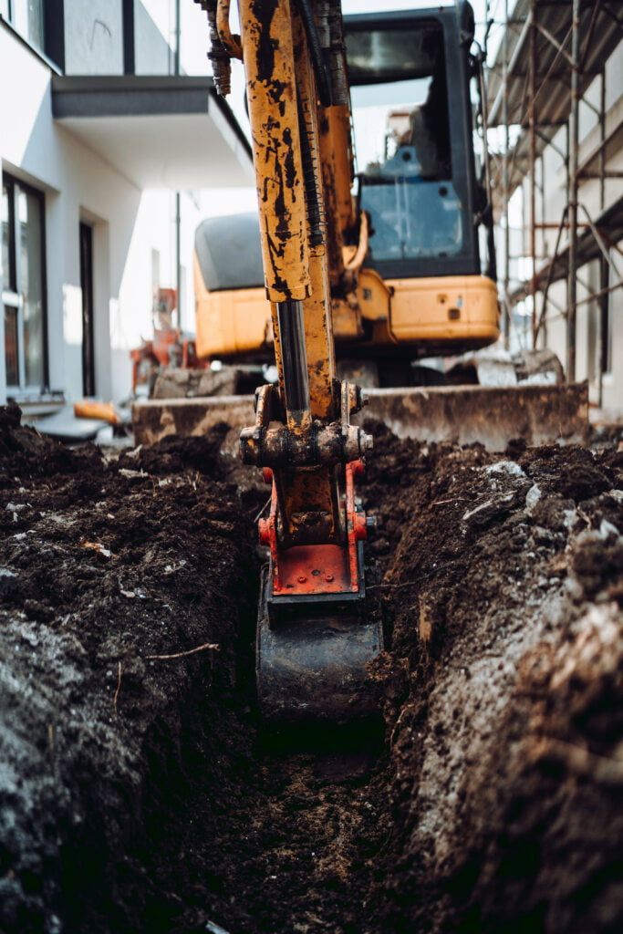 Excavator Digging a Trench in the Soil at a Construction Site — JC Excavation and Mechanical Pty Ltd in Dungog, NSW