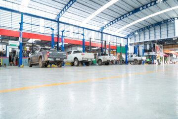 A row of cars are parked in a garage.