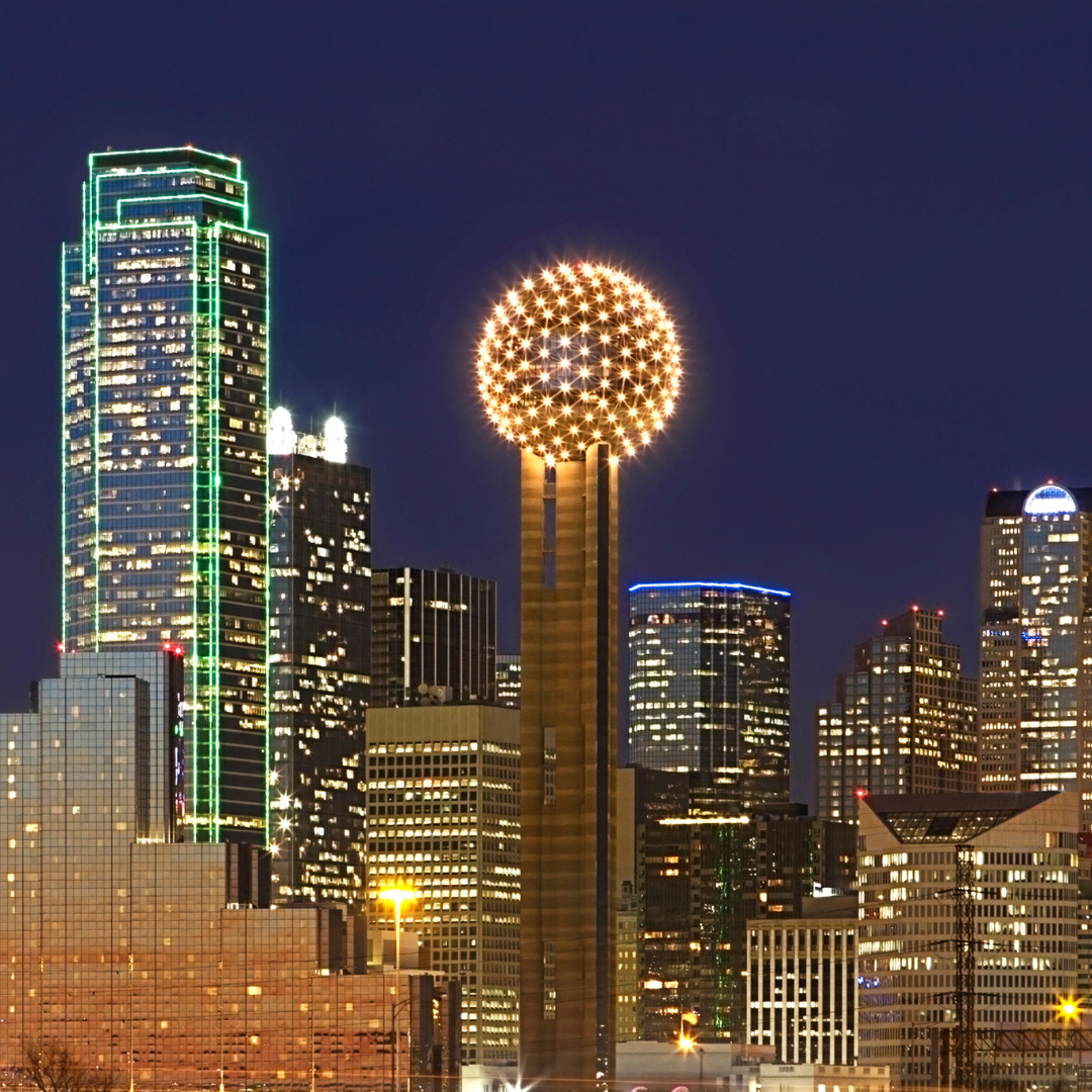 A city skyline at night with a fireworks display in the foreground
