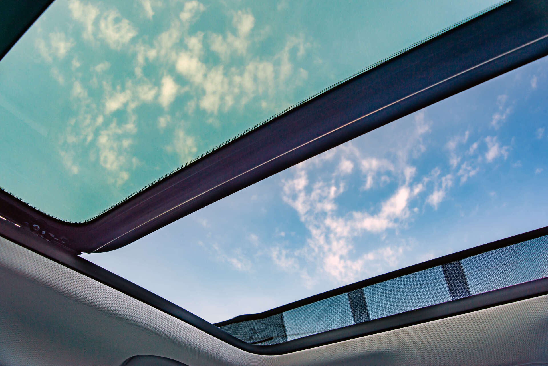 view of the sky through the car sunroof