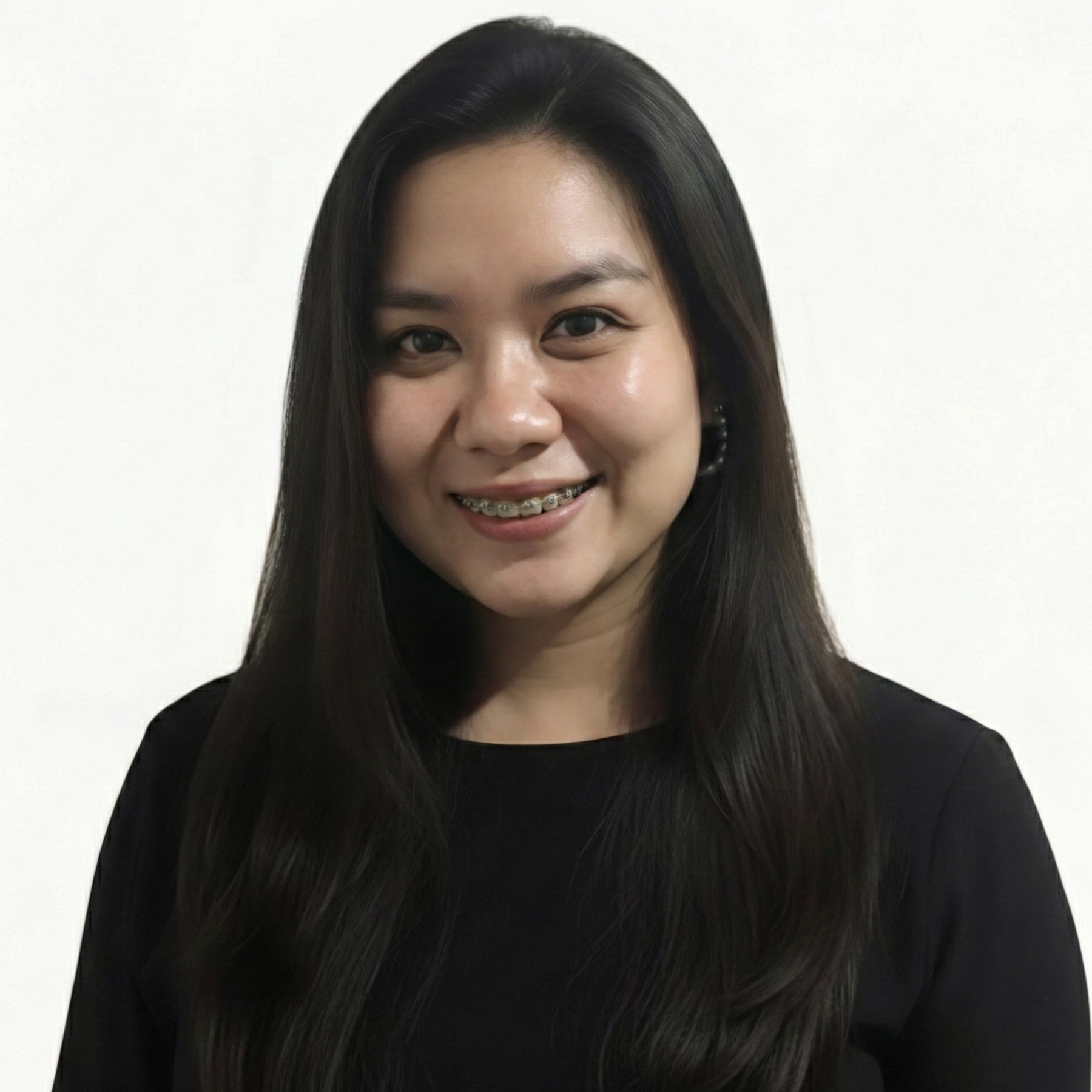 Woman in a blazer and collared shirt. Her hair is pulled back, with a gray gradient background.