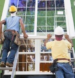 Two Workers Installing Window — Home Restoration in Kinston, NC