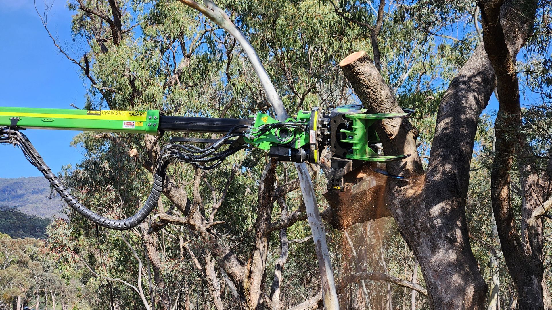 Yellow Crane Lifting a Large Tree Stump and Branches Under a Blue Sky — Agile Arbor Pty Limited in Kelso, NSW