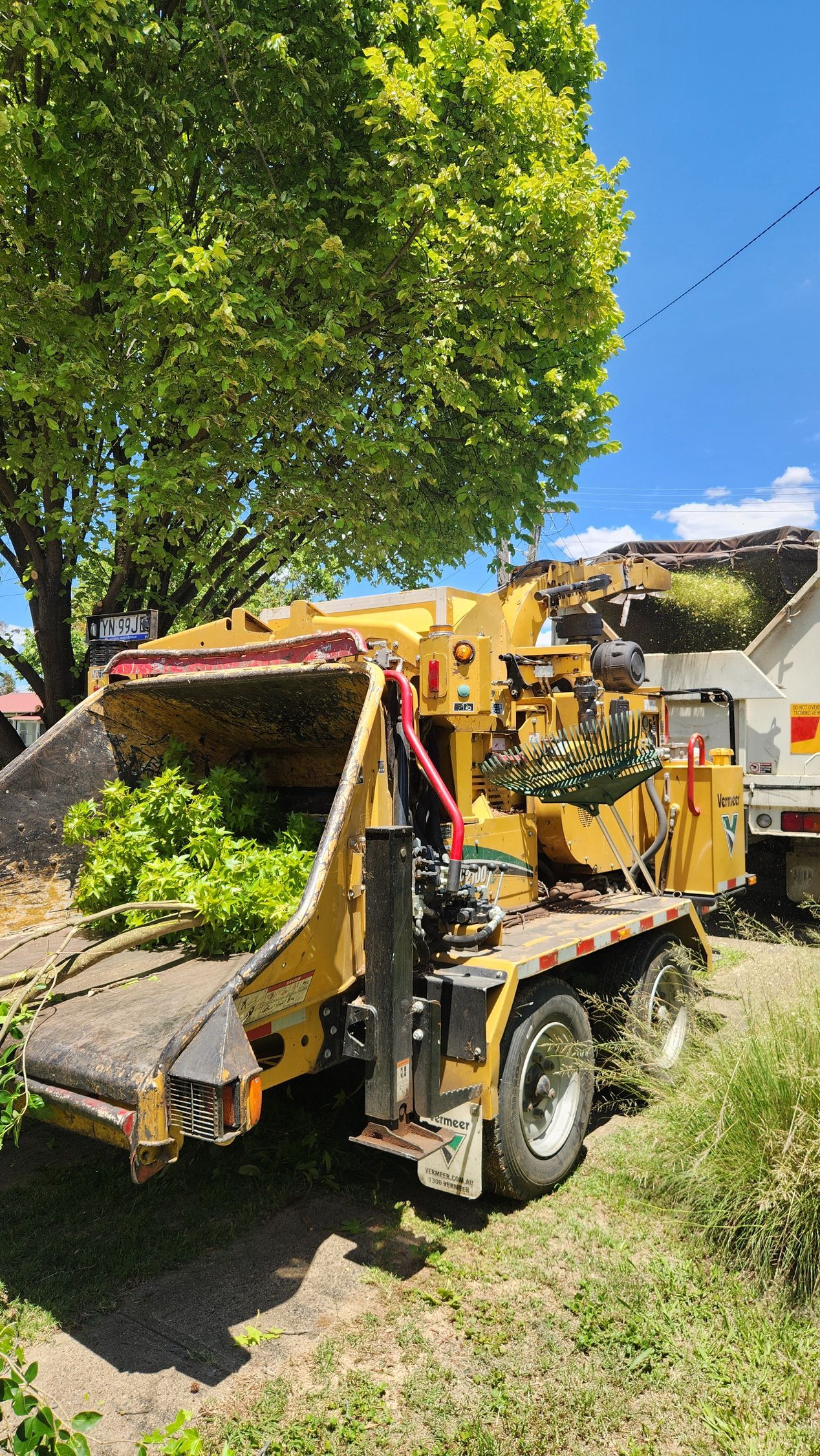 Wood Chipper and Excavator Processing Brush Roadside Under Power Lines — Agile Arbor Pty Limited in Kelso, NSW