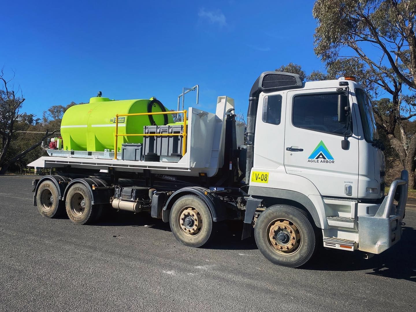 White Water Truck With a Green Tank on a Gravel Road, Under a Clear, Blue Sky — Agile Arbor Pty Limited in Kelso, NSW