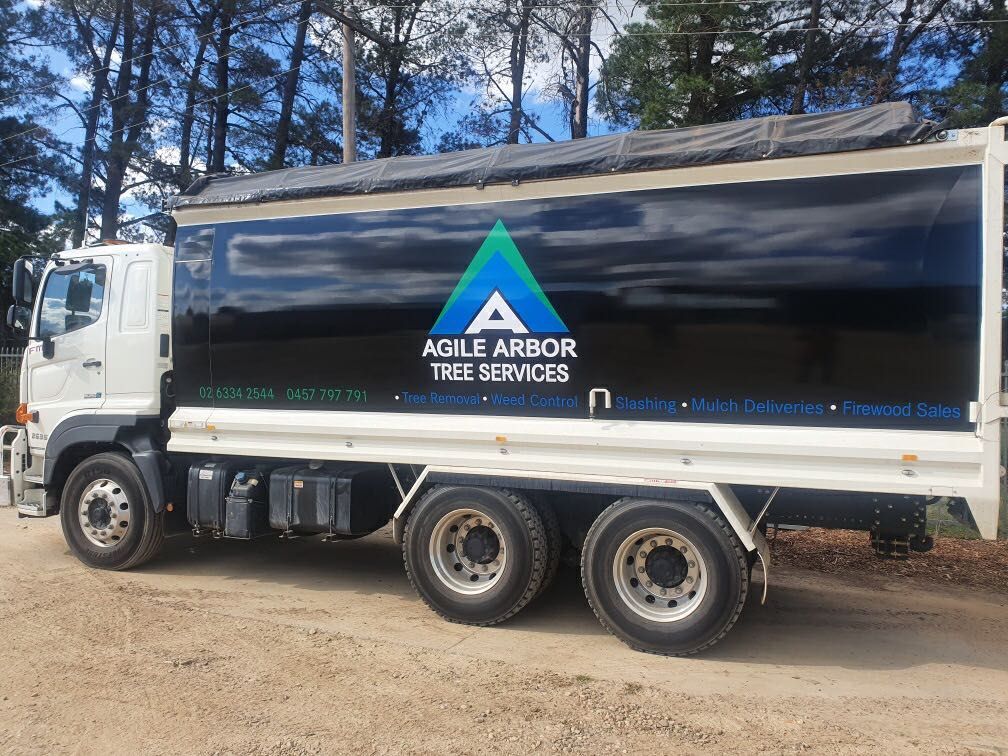 Black and White Agile Arbor Tree Services Truck on a Dirt Road — Agile Arbor Pty Limited in Kelso, NSW