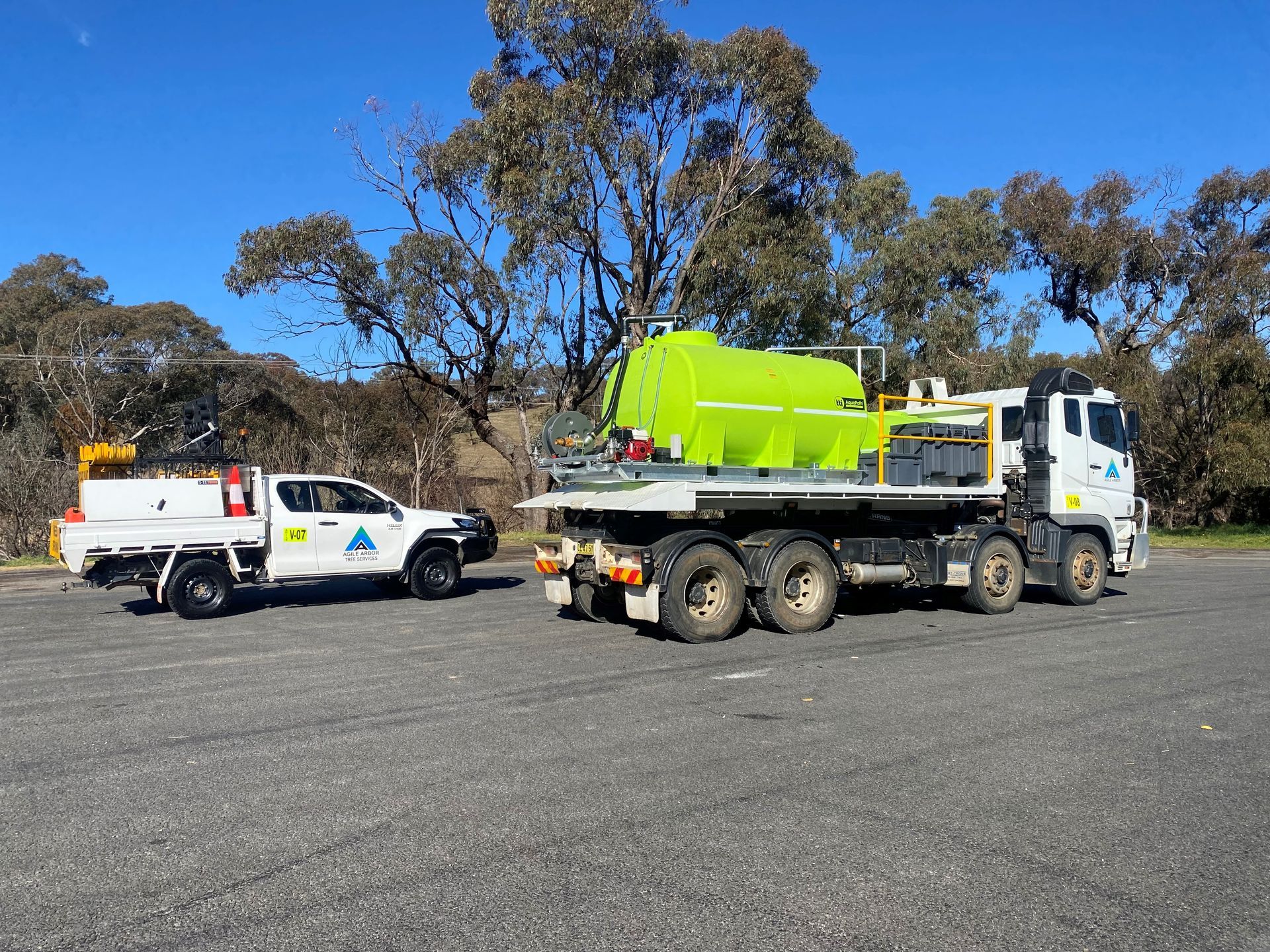 White truck and green tank truck parked outdoors — Agile Arbor Pty Limited in Kelso, NSW