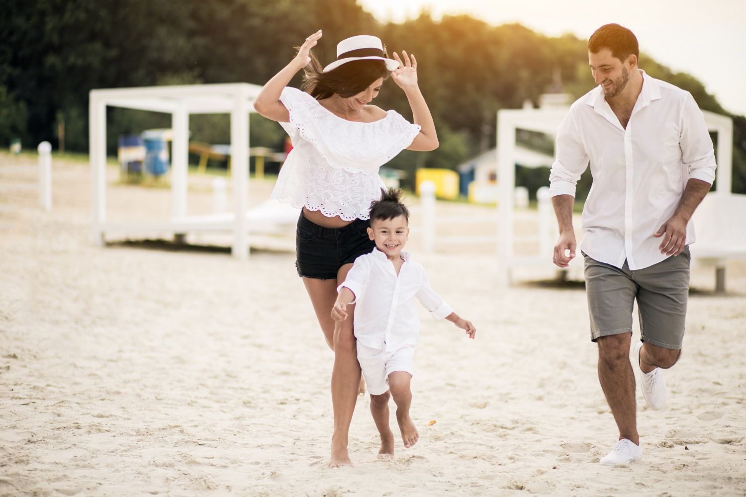 A family is walking on the beach.