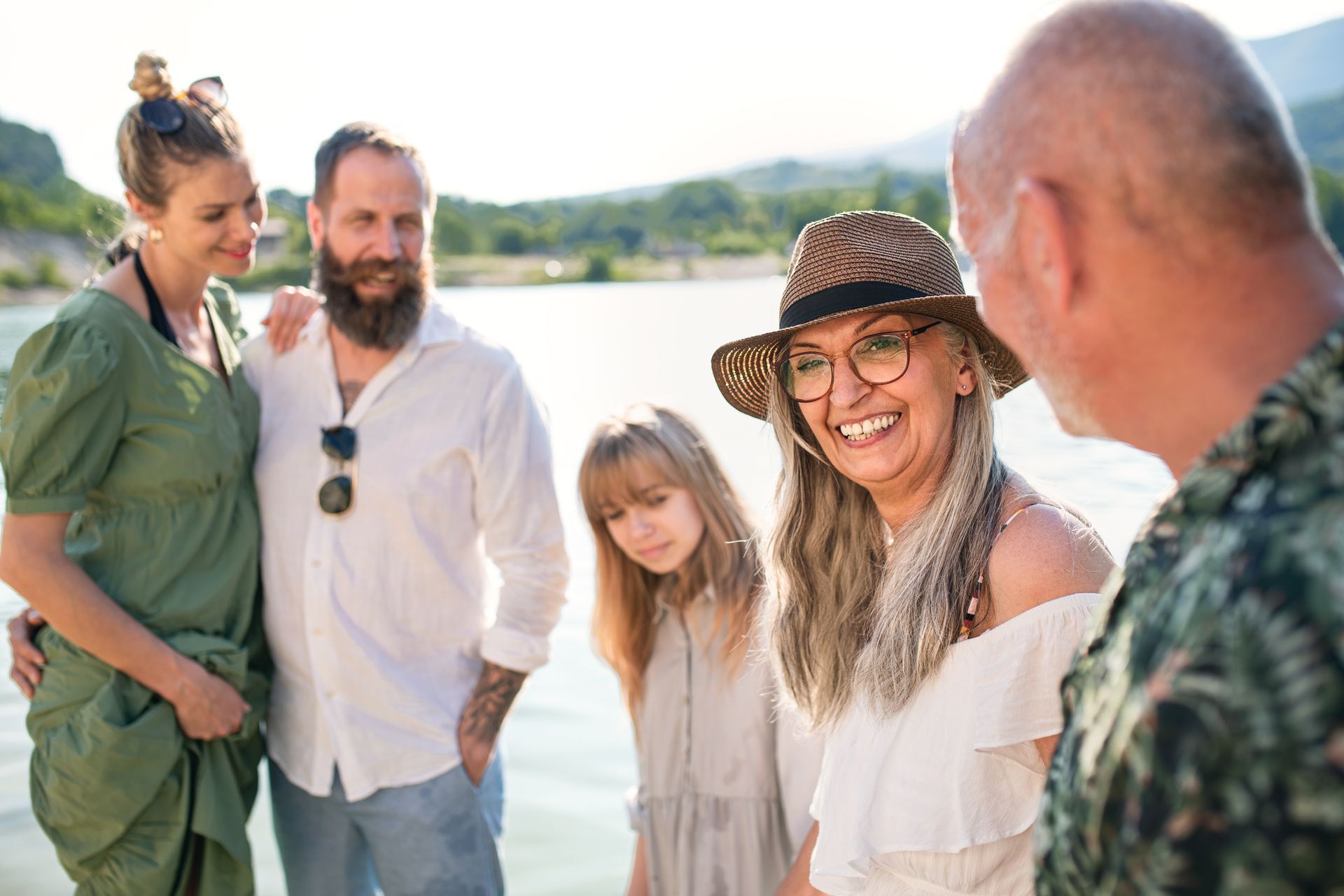 A group of people are standing next to each other on the beach.