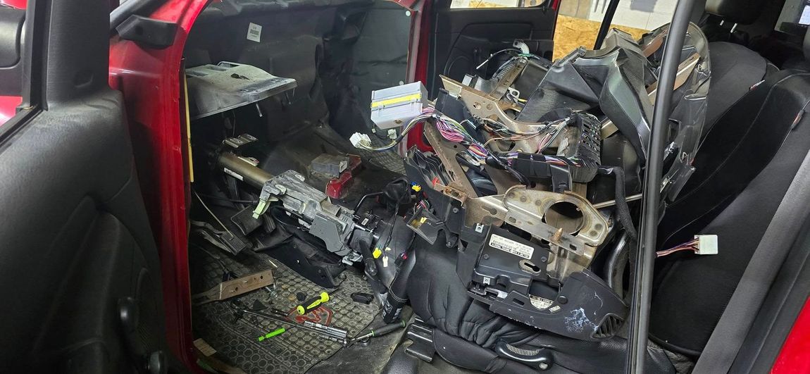 The inside of a red car that has been damaged in a car accident.