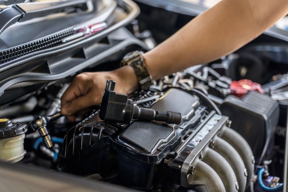 A person is working on the engine of a car.