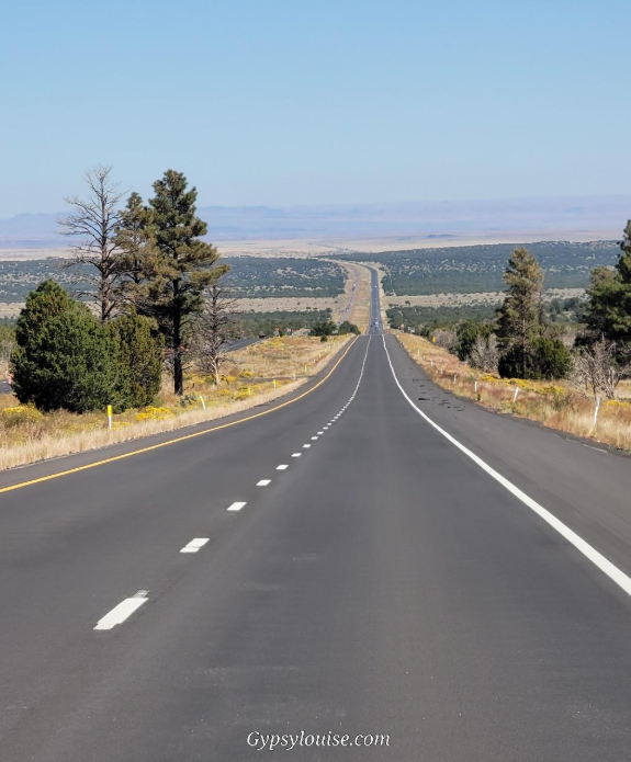 Open highway stretching through the high desert near Flagstaff, Arizona.
