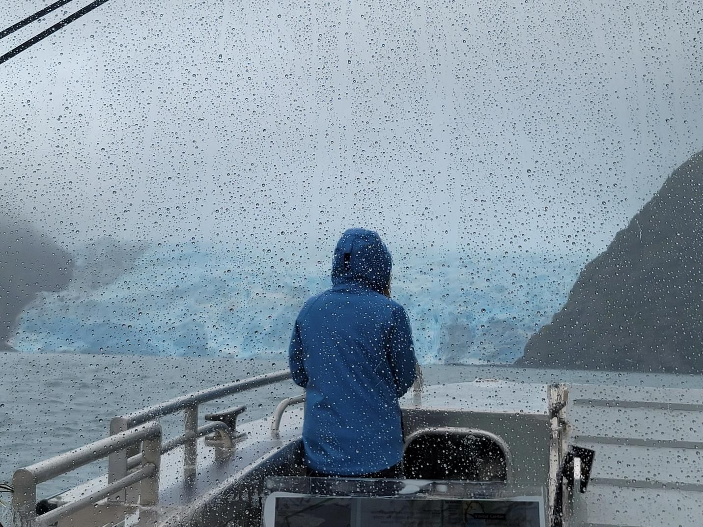 Glacier in Kenai Fjords National Park and rough waters during a boat tour on a stormy day