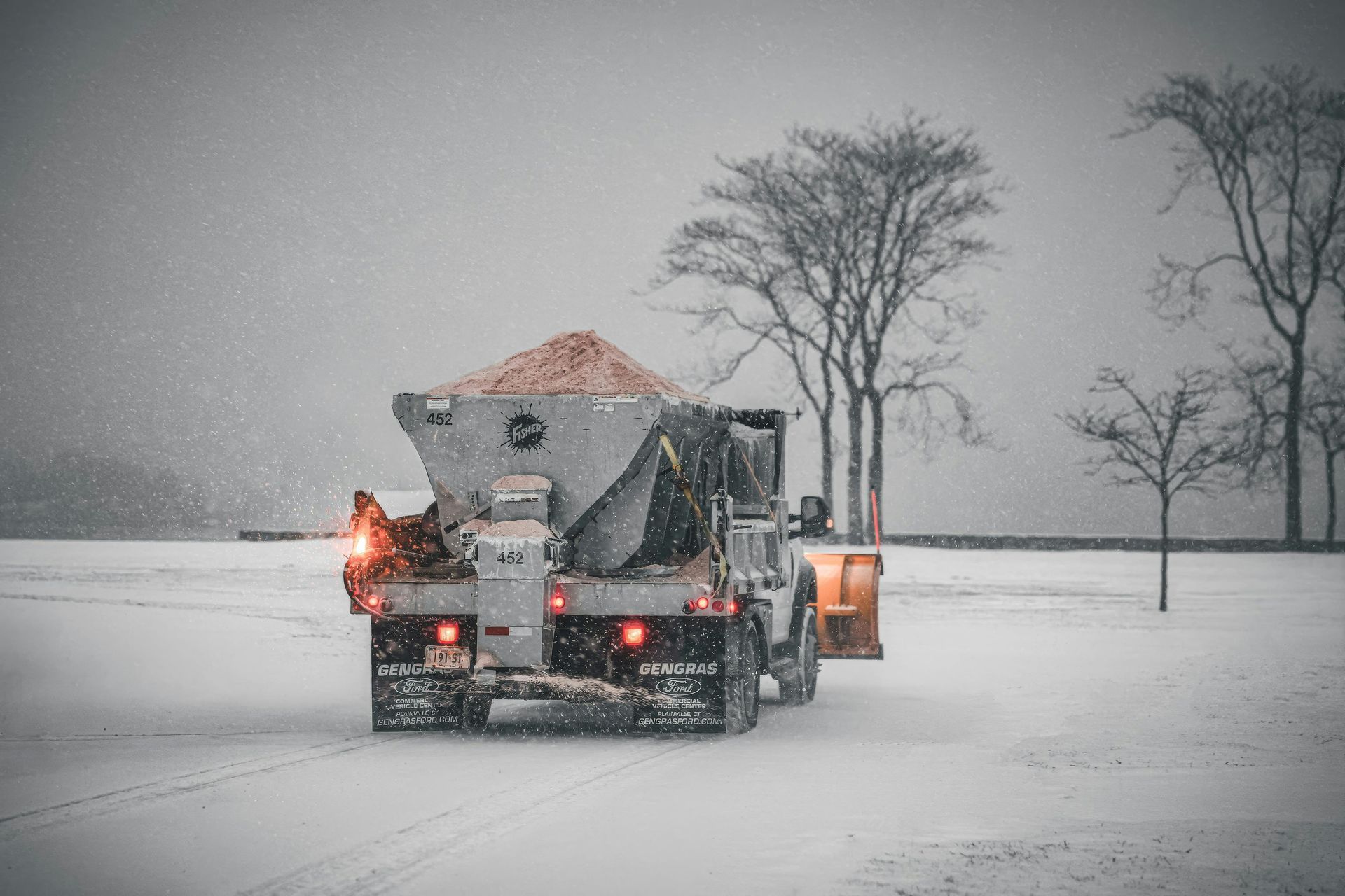 truck carrying ice and spreading it onto the road