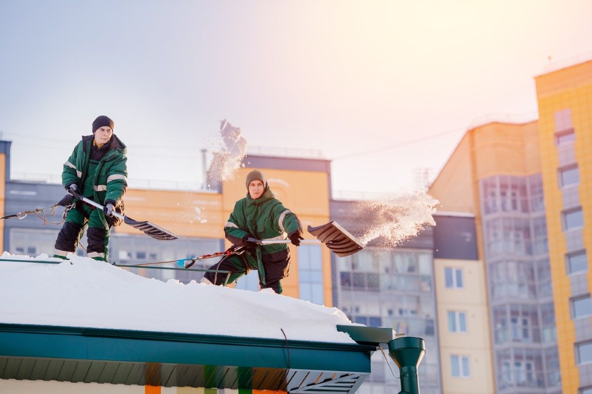 snow being removed from a greenhouse