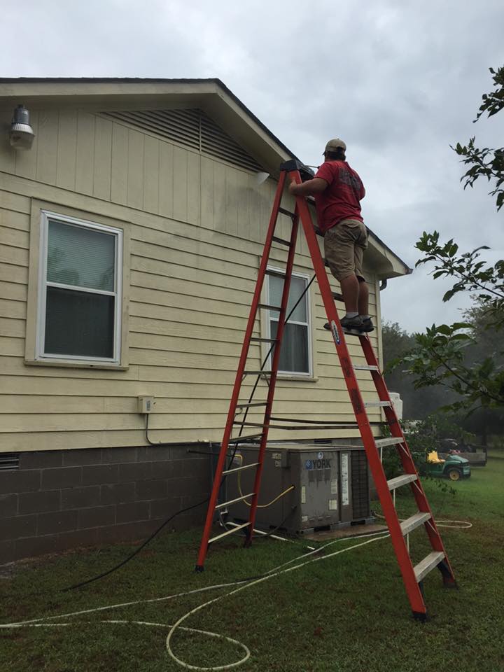 Man on ladder cleaning house — Morrilton, AR — Chadek Power Wash