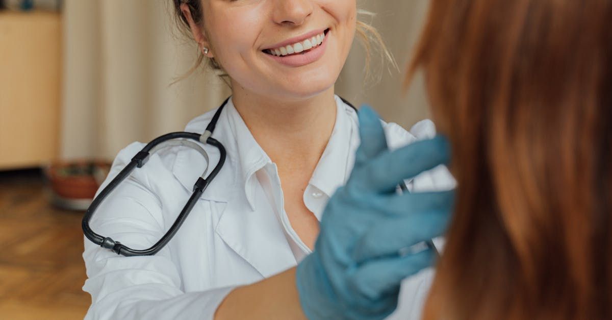 A female doctor is smiling while talking to a patient.