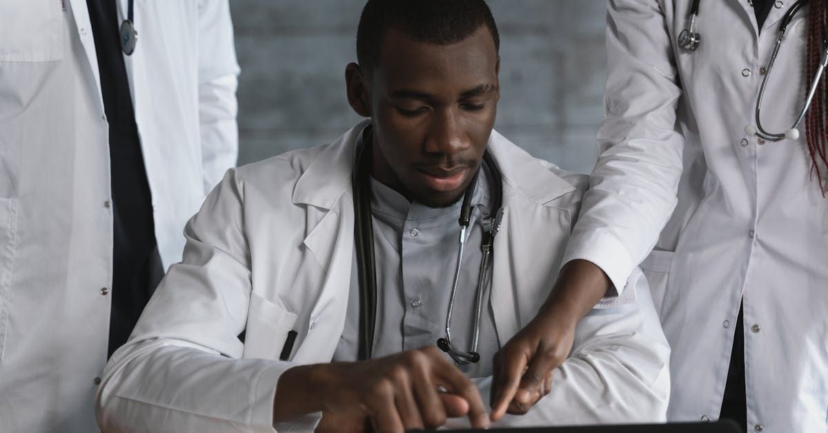 A group of doctors are looking at a tablet computer.