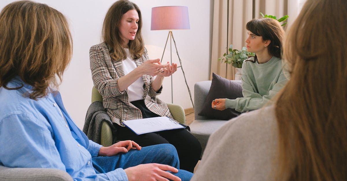 A group of people are sitting in a circle having a conversation.