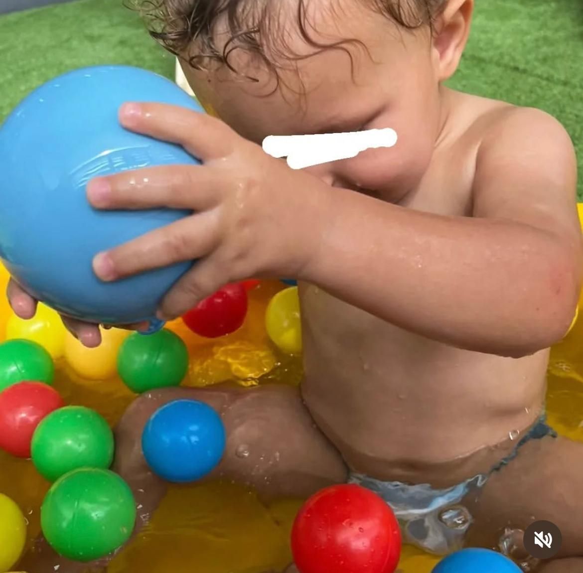 un bimbo gioca con delle palline colorate