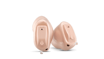 A pair of hearing aids on a white background.