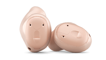 A pair of hearing aids sitting next to each other on a white background.