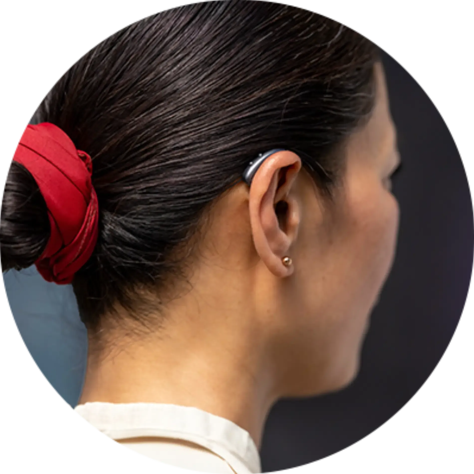 A woman wearing a hearing aid in her left ear