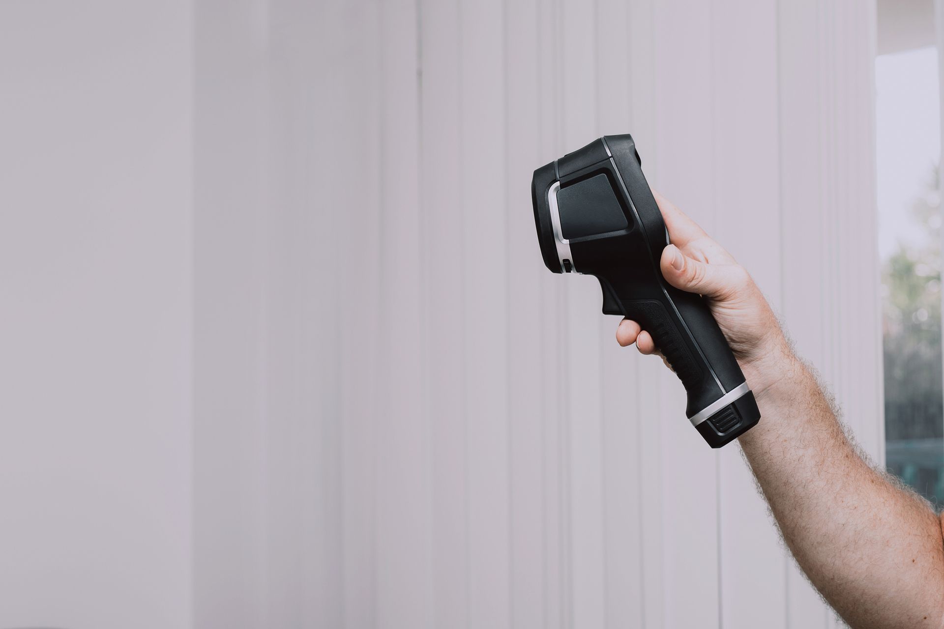 A person is holding a thermometer in their hand.